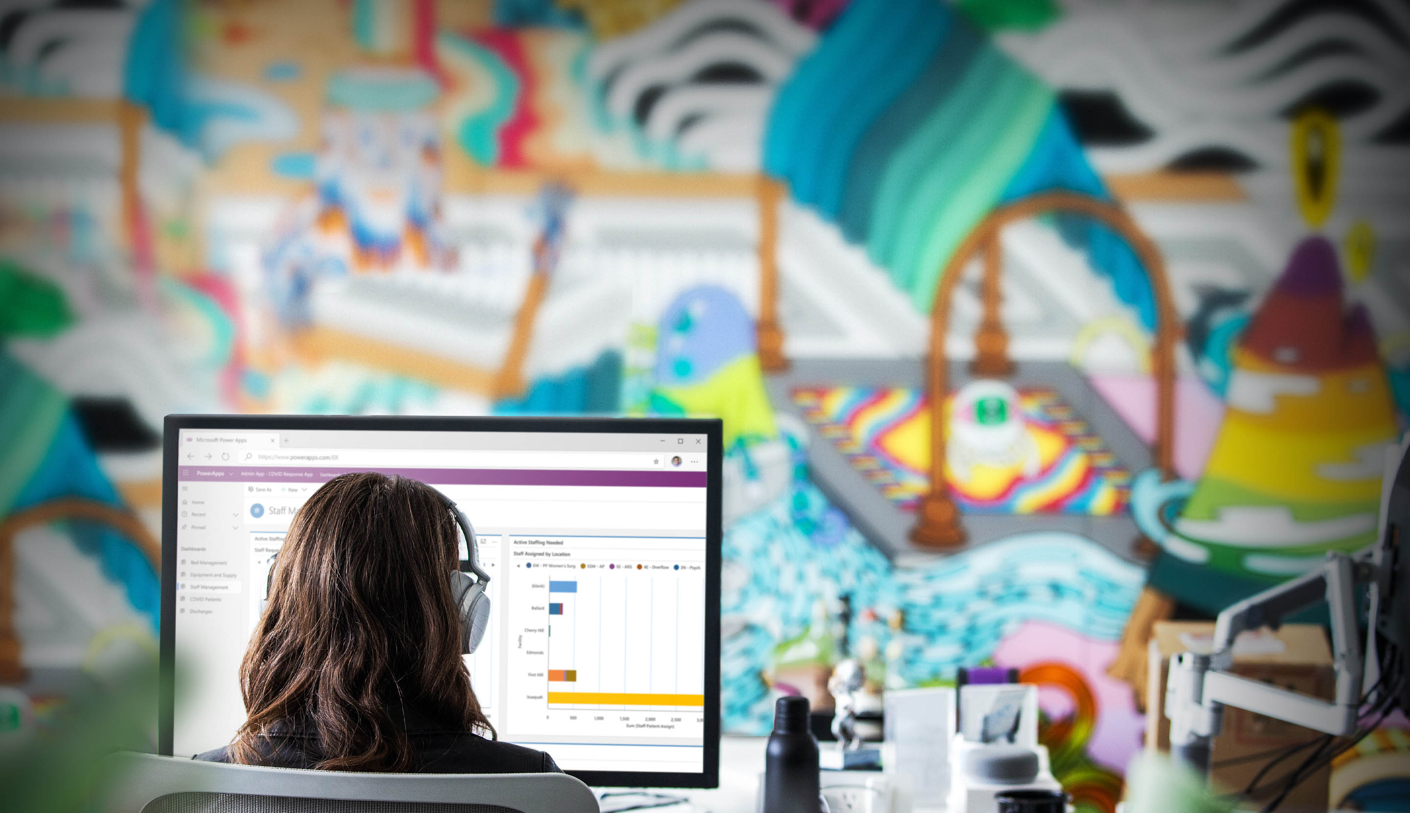 Woman sitting in front of computer running Microsoft Power Apps